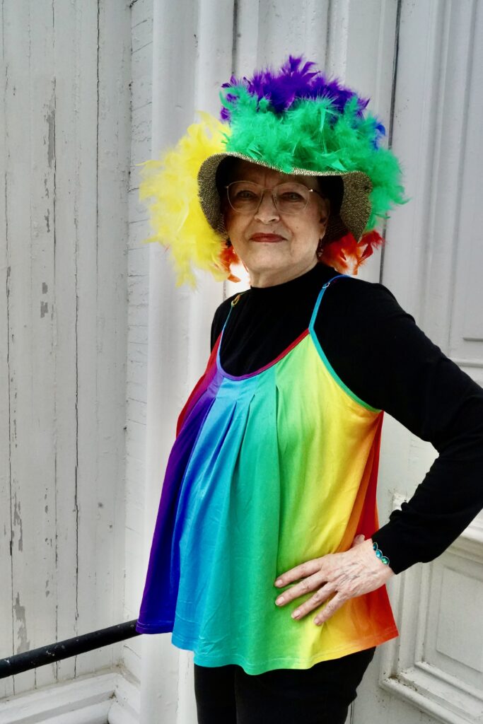 Attendee in a rainbow outfit