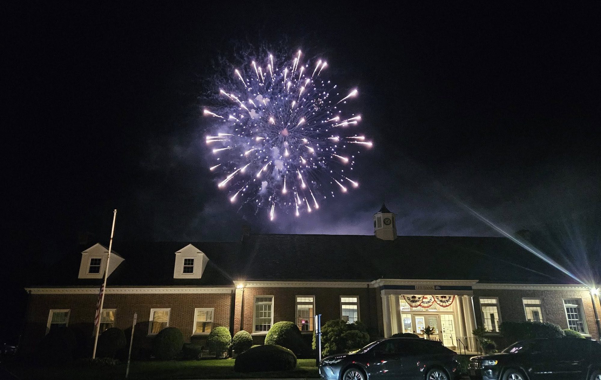Fireworks bursting in the night sky over Lee Bank on Main Street in Lee, Massachusetts