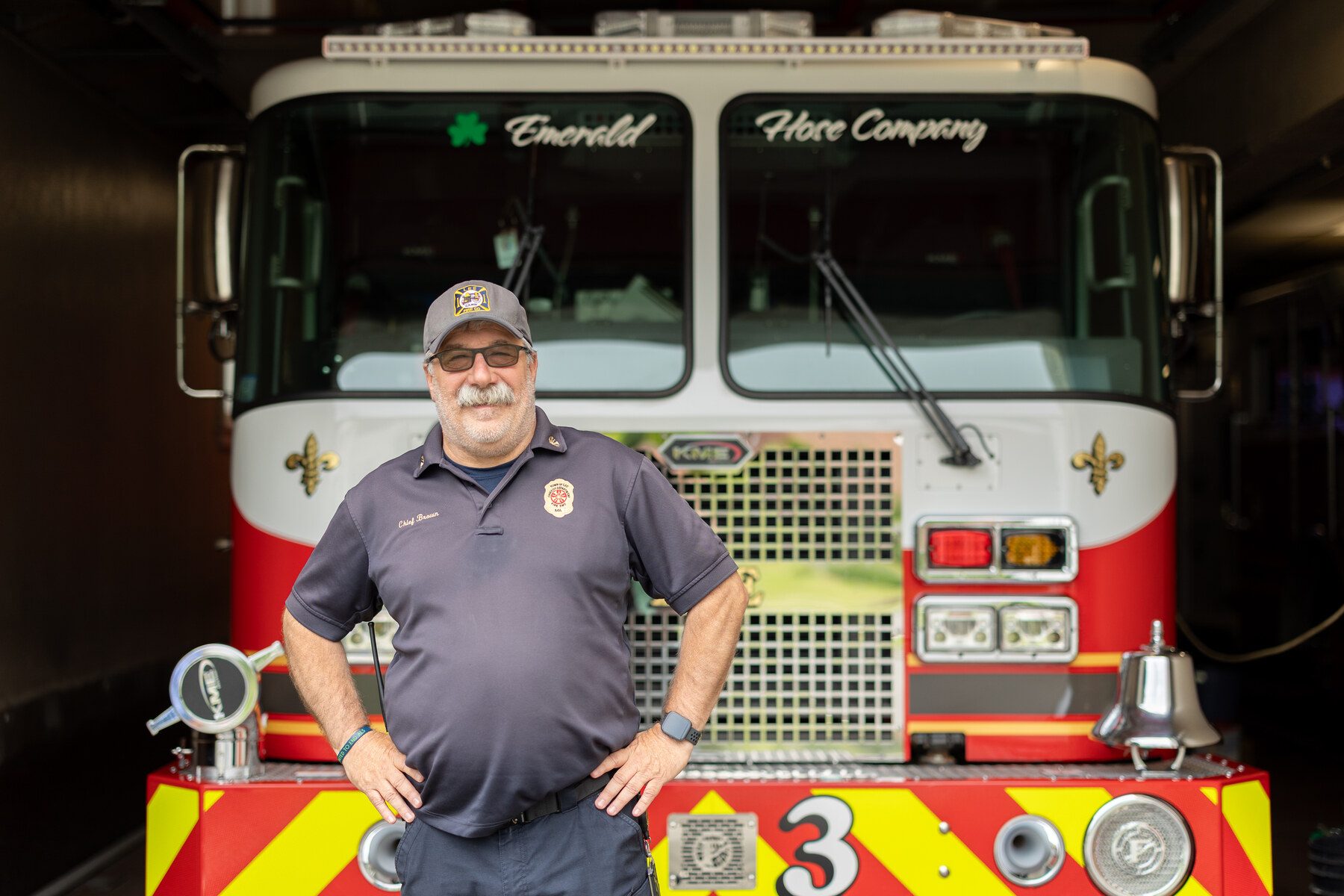 A Lee firefighter beside a fire engine at the local fire company